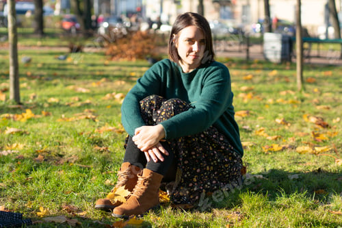 Preview: Young Beautiful Girl Sitting On The Ground In Autumn