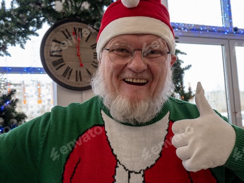 Preview: Elderly Man With Gray Beard And Mustache Wearing Santa Claus Hat And Carnival Clothes In Festive
