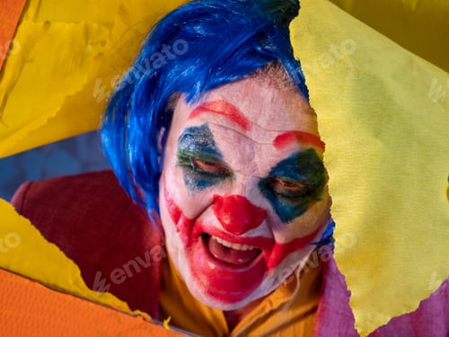 Preview: Portrait Of Male Clown In Pink Dressed For Halloween. Actor Made Makeup From Crazy Evil Clown