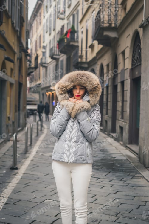 Preview: Beautiful Young Brunette With Furry Hood Posing In The City Streets