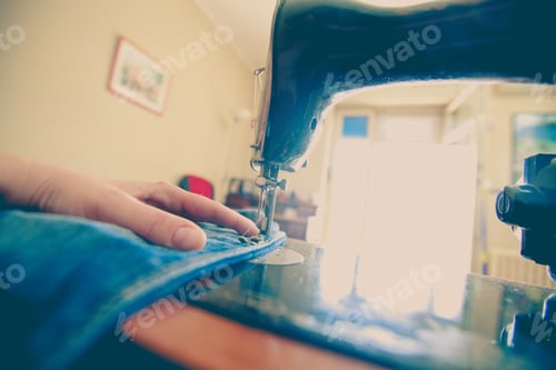 Preview: Closeup Of Woman Tailor Working With Old Sewing Machine At Home. Vintage Edited Photo.