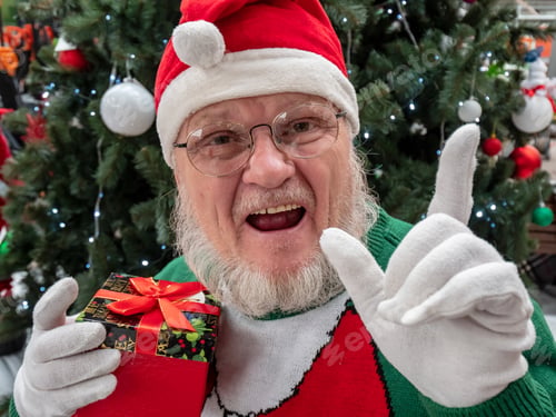 Preview: Elderly Man With Gray Beard And Mustache Wearing Santa Claus Hat And Carnival Clothes In Festive