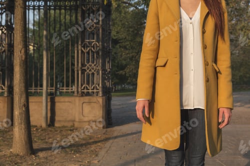 Preview: Detail Of Girl With Yellow Coat Posing In A City Park