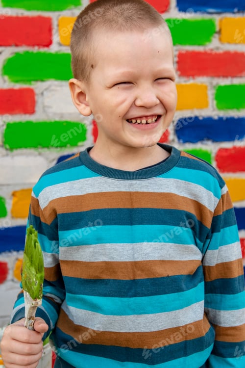 Preview: Happy Charming Caucasian Child Painting Wooden Boat Against Brick Wall Background. Brush, Container