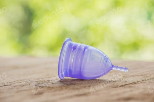 Preview: Feminine Hygiene Product - Menstrual Cup On A Wooden Background