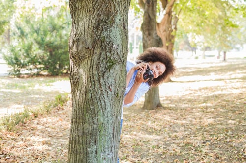 Preview: African American Woman Taking Photo In Nature With Old Retro Camera , Female Photographer Fun