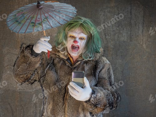 Preview: Crazy Aggressive Clown With Smartphone, Umbrella. Man Hates His Work And In His Free Time Dresses