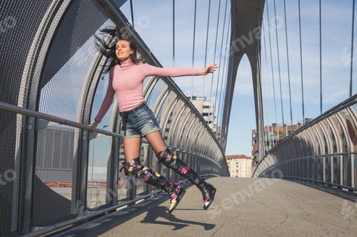 Preview: Beautiful Young Brunette With Over The Knee Boots Jumping On A Bridge
