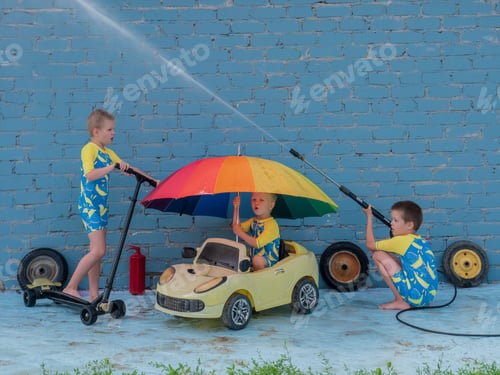 Preview: Funny Children In Boys' Bathing Suits Posing In Front Of Camera With High-Pressure Car Wash And Toy