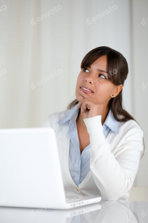 Preview: Portrait Of A Pensive Young Woman Working On Laptop Computer - Copy Space