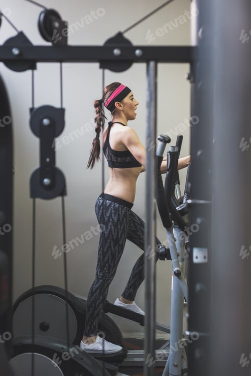 Preview: Beautiful Young Girl Doing Workout In The Gym. Concept Of Health And Fitness.