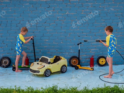 Preview: Funny Children In Boys' Bathing Suits Posing In Front Of Camera With High-Pressure Car Wash And Toy