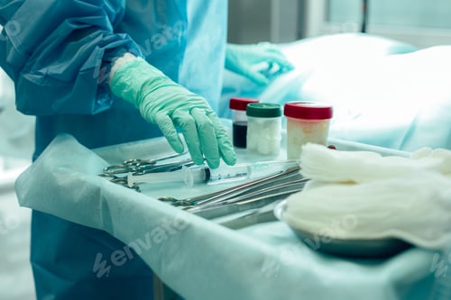Preview: Cropped Photo Of An Operating Theatre With Necessary Instruments On The Tray. Hand Of A Medical
