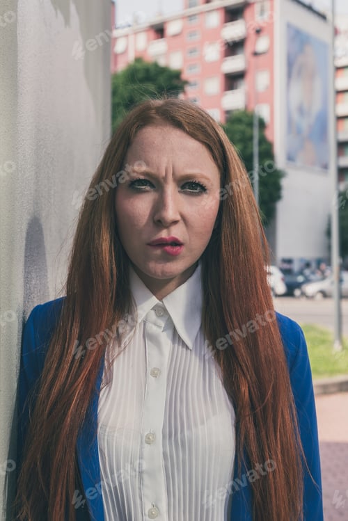 Preview: Beautiful Redhead Girl In Blue Jacket Posing In An Urban Context