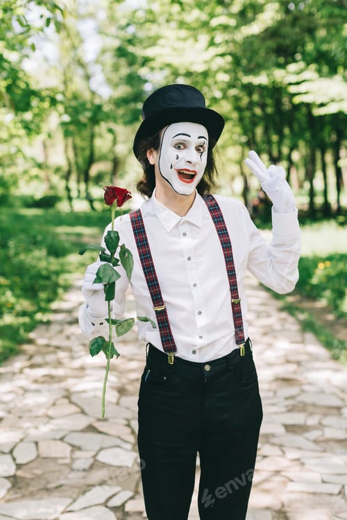 Preview: Emotional Male Mime Artist With Red Rose Performing Love On A Outdoor.