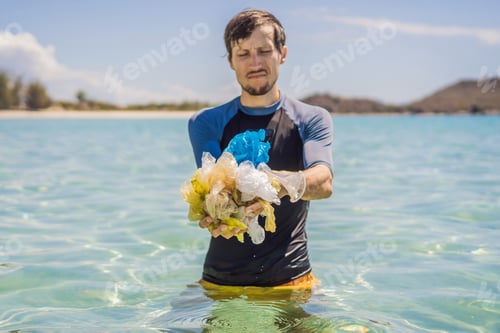 Preview: Man Collects Packages From The Beautiful Turquoise Sea. Paradise Beach Pollution. Problem Of