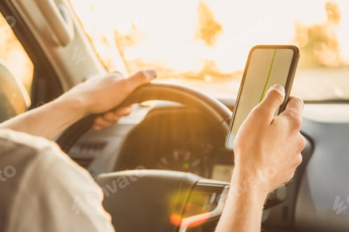 Preview: A Tourist Is Sitting In A Car And Looking For The Road In The Navigator App On A Sunny Day