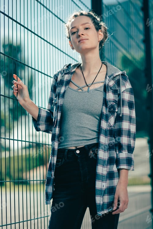 Preview: Young Woman Poses in front of Fence