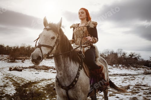 Preview: Viking Girl With Grey Horse Against The Background Of Mountains. Reconstruction Of A Medieval
