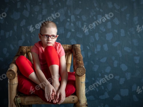Preview: Caucasian Child In Pink T-Shirt And Pantyhose Sits In Chair