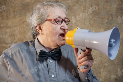 Preview: Beautiful Senior Woman Is Excited, Euphoric, Screaming With Megaphone, Sign Of Revolution And