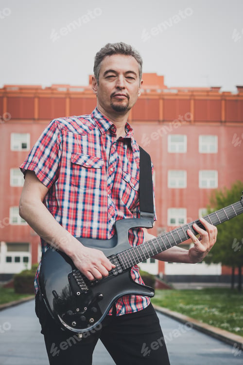 Preview: Man In Short Sleeve Shirt Playing Electric Guitar In The Street