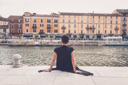 Preview: Young Handsome Asian Model Dressed In Black Tunic Sitting By An Artificial Basin