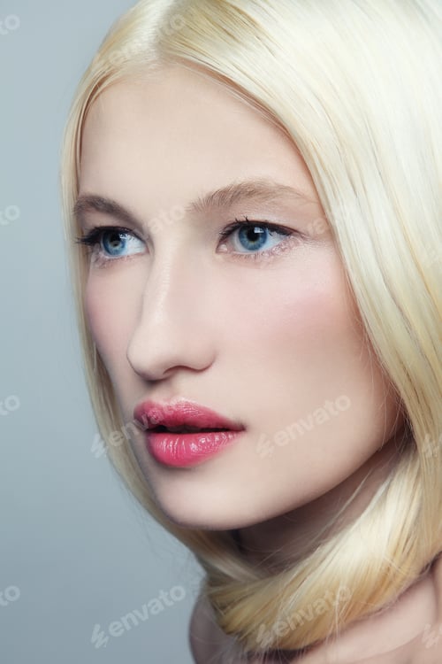Preview: Portrait Of Young Beautiful Fresh Woman With Long Bleached Hair And Clear Make-Up Looking Upwards