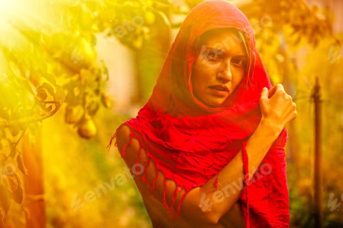 Preview: Beautiful Young Girl Trying On A Red Scarf. Autumn Time For Harvest. Orchard. The Concept Of