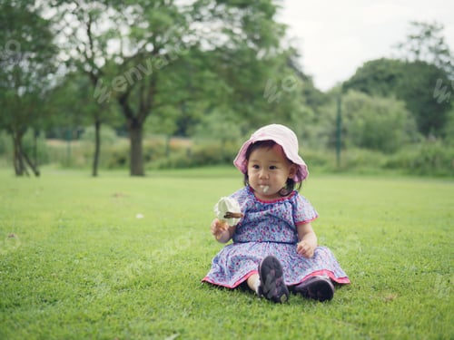 Preview: Baby Girl Eating Icecream In Summer Garden
