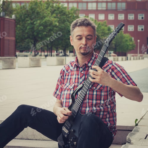 Preview: Man In Short Sleeve Shirt Playing Electric Guitar In The Street