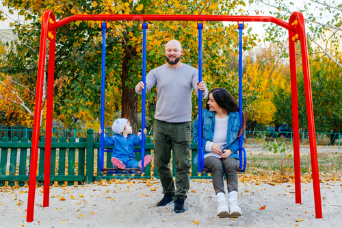 Preview: Happy Family With Little Kid On The Children Ground Playing All Together