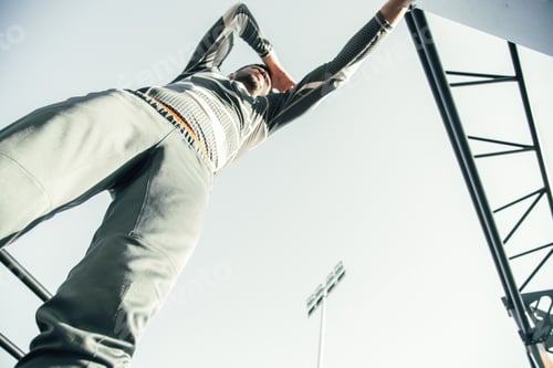 Preview: Bottom View Of Young Professional Sportsman Standing At The Sports Ground And Putting One Hand On
