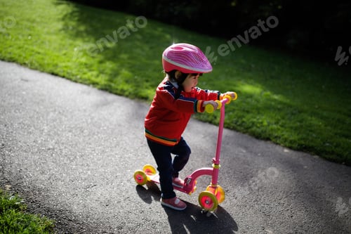 Preview: Baby Girl Play Scooter In Forest Park