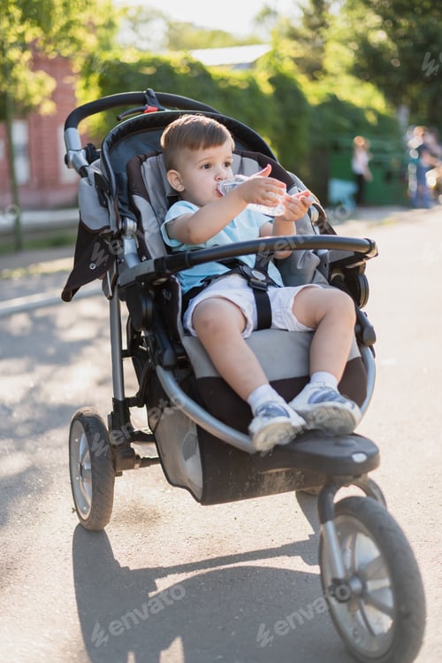 Preview: Toddler Drinks Water While Sitting in Stroller