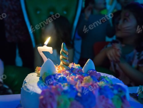 Preview: Closeup Of Birthday Cake With Candle And Dessert Decoration On Party In Playroom