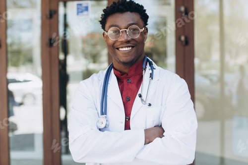 Preview: Handsome African Male Doctor Outside Of Hospital Building.