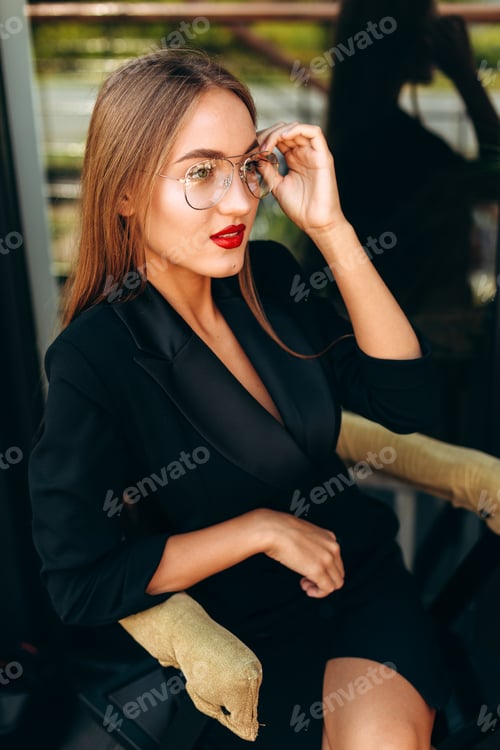 Preview: Stylish Woman in Black Suit Adjusting Glasses