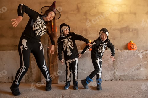 Preview: Happy Children In Carnival Costumes, Boys With Mother In The Garage. Black Suit With The Image Of