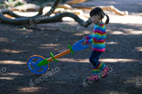 Preview: Young Girl Playing Outdoor Measure-Mate In The Forest Park For Leaning Measurement