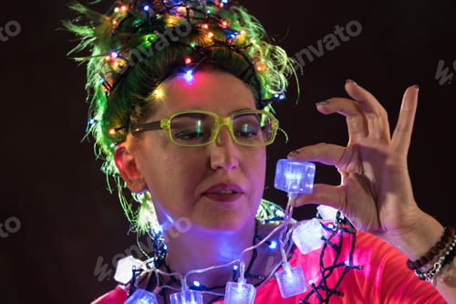 Preview: A Beautiful Girl In A Pink Dress With Green Hair Decorated Herself With Christmas Garlands. Her