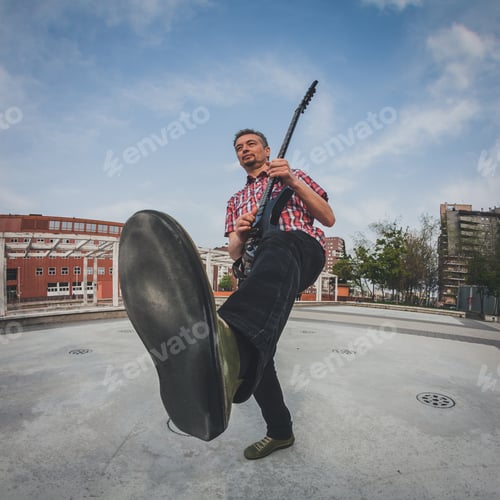 Preview: Man In Short Sleeve Shirt Playing Electric Guitar In The Street