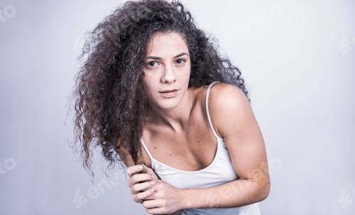 Preview: Beautiful Curly Haired Female Model Posing In Studio. Isolated