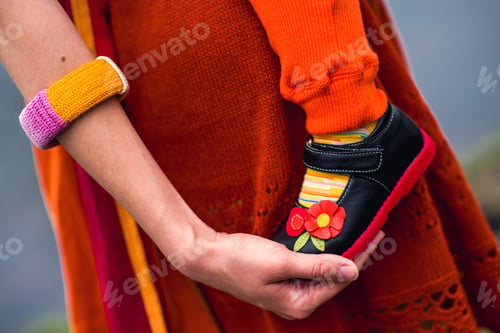 Preview: A Child In A Sling On Her Mother