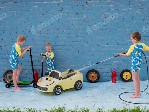 Preview: Funny Children In Boys' Bathing Suits Posing In Front Of Camera With High-Pressure Car Wash And Toy