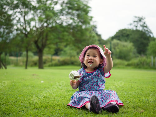 Preview: Baby Girl Eating Icecream In Summer Garden