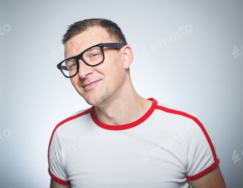Preview: Smile Nerd Looking, Head And Shoulders Portrait Of Funny Guy Against Gray Background
