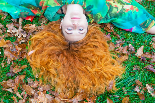 Preview: Woman With Beautiful Red Hair On The Ground In Autumn