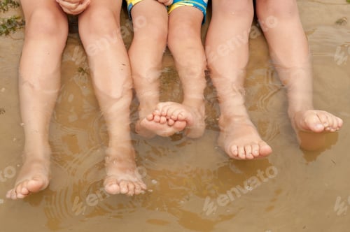 Preview: Funny Kids In Bathing Suits Sit Together On Sand With Their Legs In Water. Boys Are Happy On