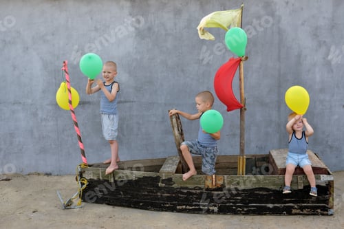 Preview: The Boys Play With Balloons On A Wooden Boat Converted Into A Toy Ship In The Courtyard Of A House